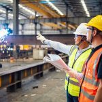 Quality inspectors working in a steel factory