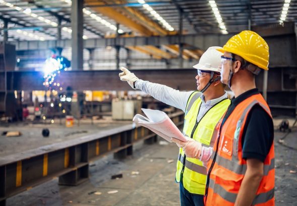 Quality inspectors working in a steel factory