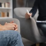 woman-with-hands-together-talking-with-counselor